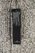Speckled jacket with full zipper and hanging Stone Island label at center chest