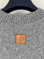 Gray knit long-sleeve sweater with ribbed crew neck and Louis Vuitton leather logo patch