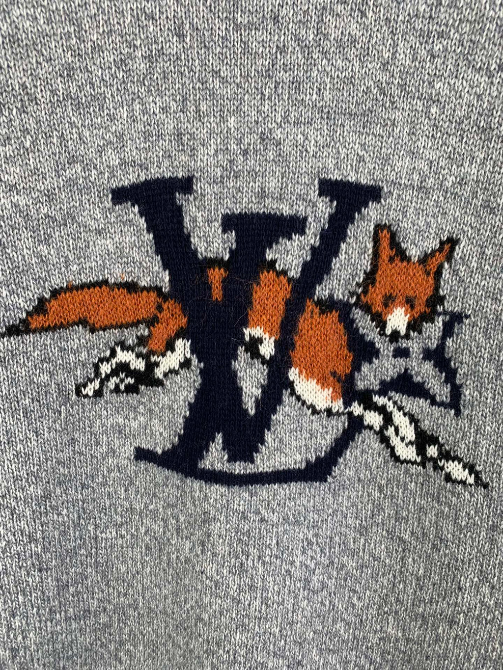 Grey knit sweater front graphic detail with LV-style letters and animals