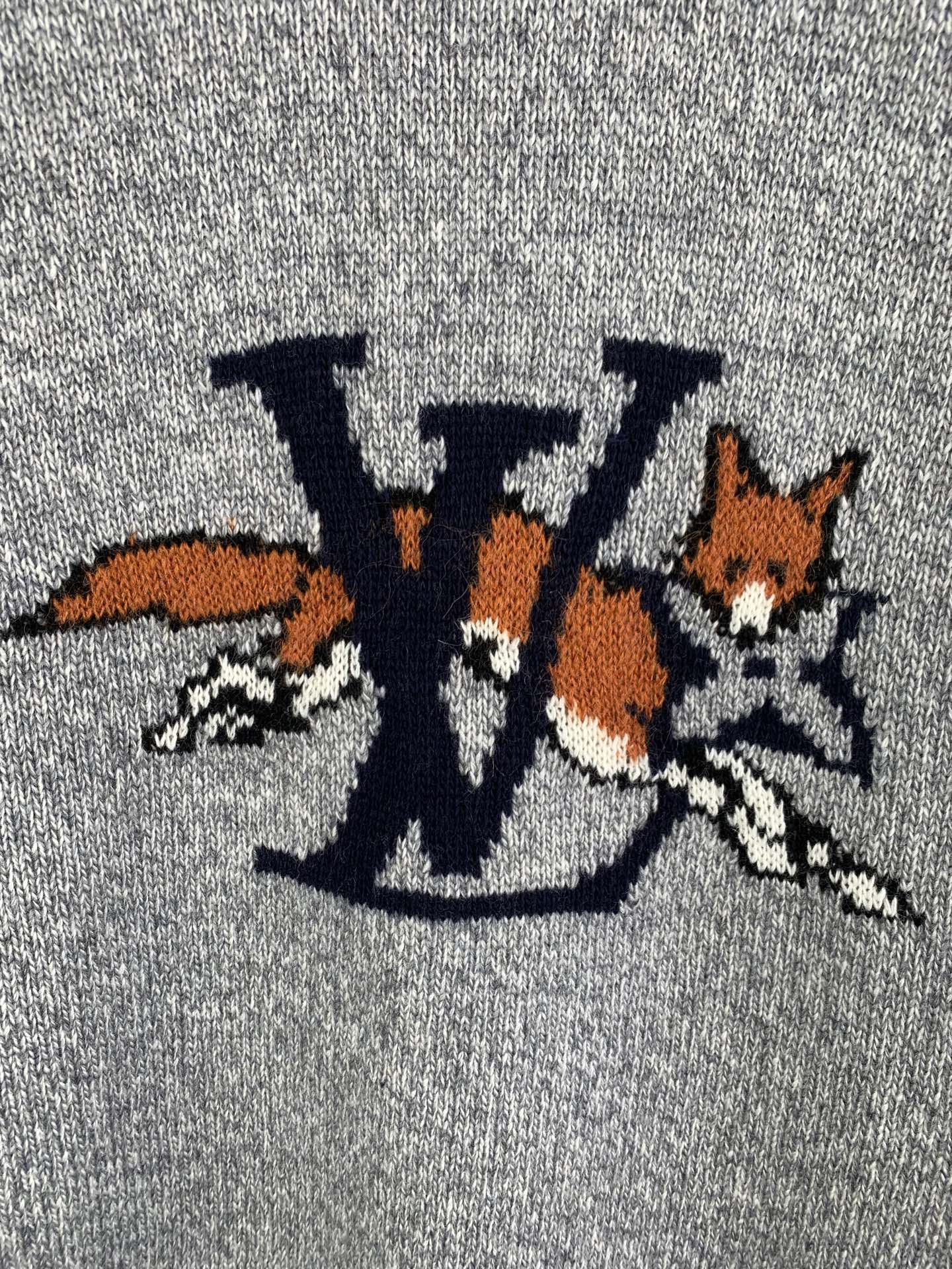 Grey knit sweater front graphic detail with LV-style letters and animals