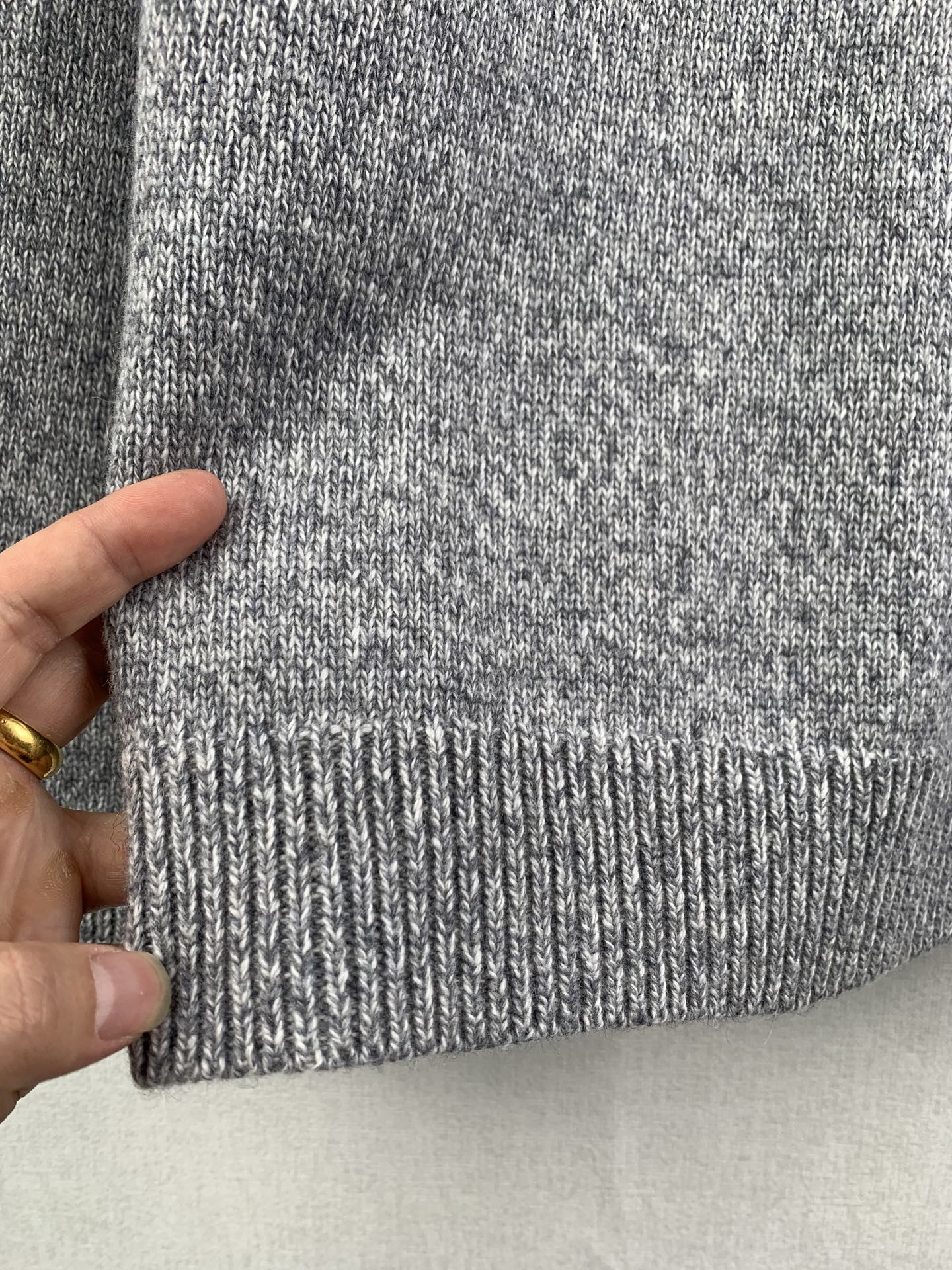 Grey knit sweater ribbed hem detail
