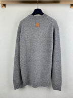 Grey long-sleeve knit sweater back view with small leather-style patch