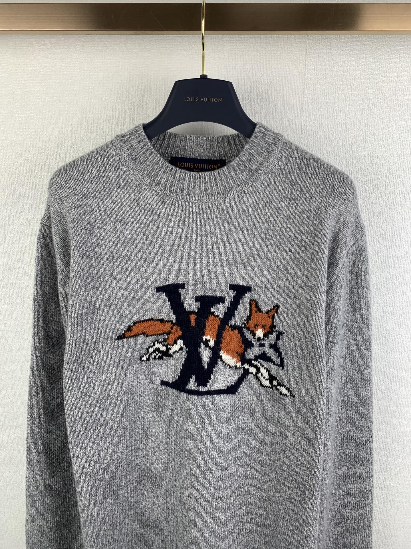 Grey crewneck knit sweater with LV-style logo graphic on chest