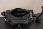 Black Prada crossbody bag with open zip top and inner fabric lining