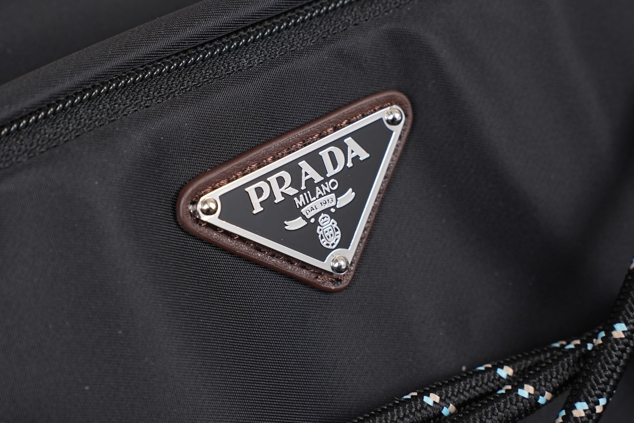 Prada Milano logo patch on brown leather trim