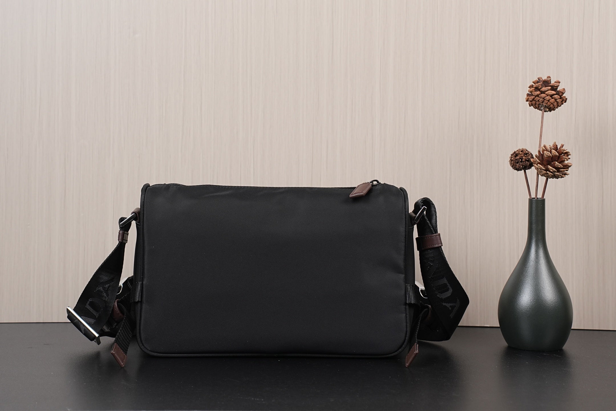 Black Prada crossbody bag with front flap and side strap hardware