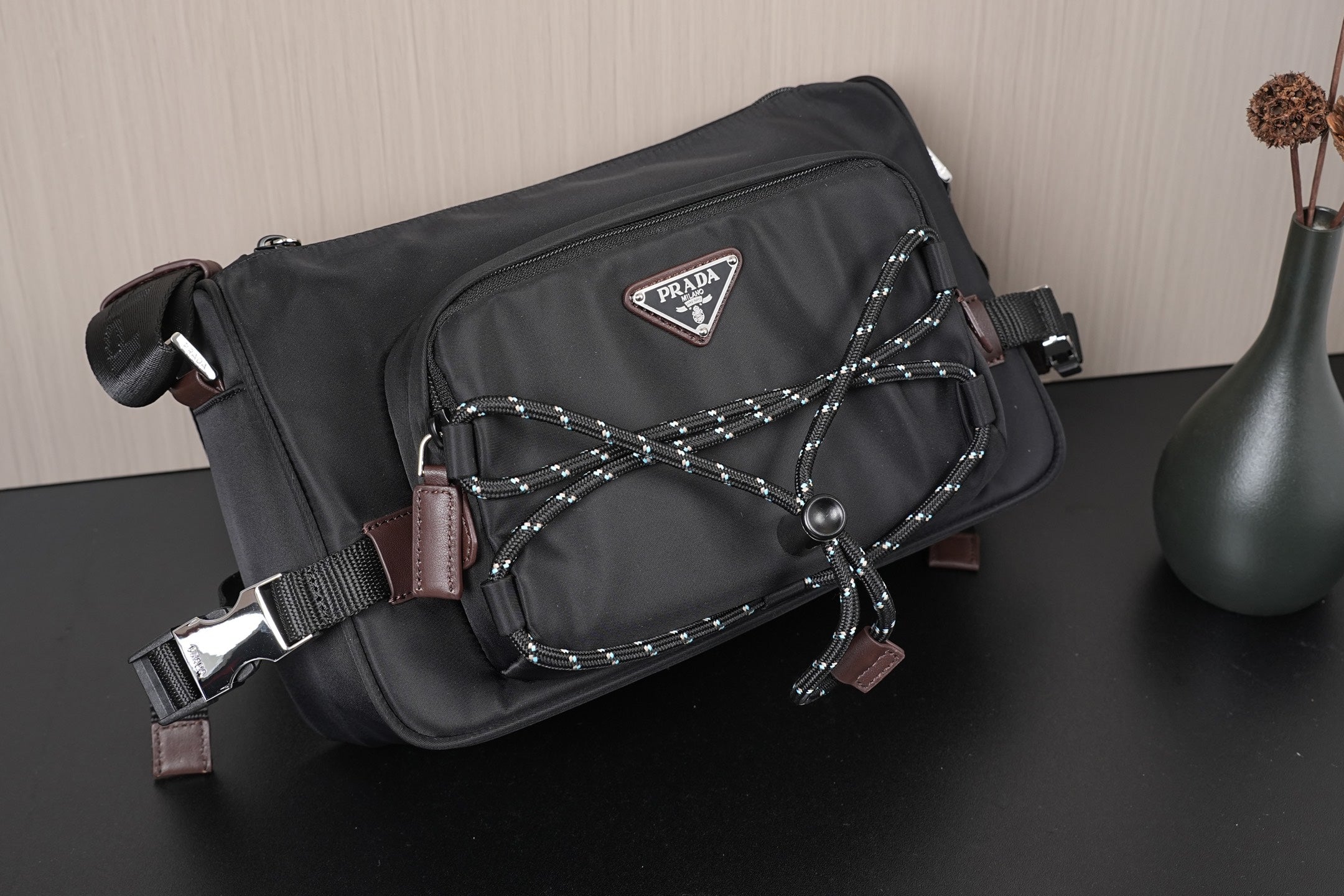 Black Prada crossbody bag front with triangular logo plaque