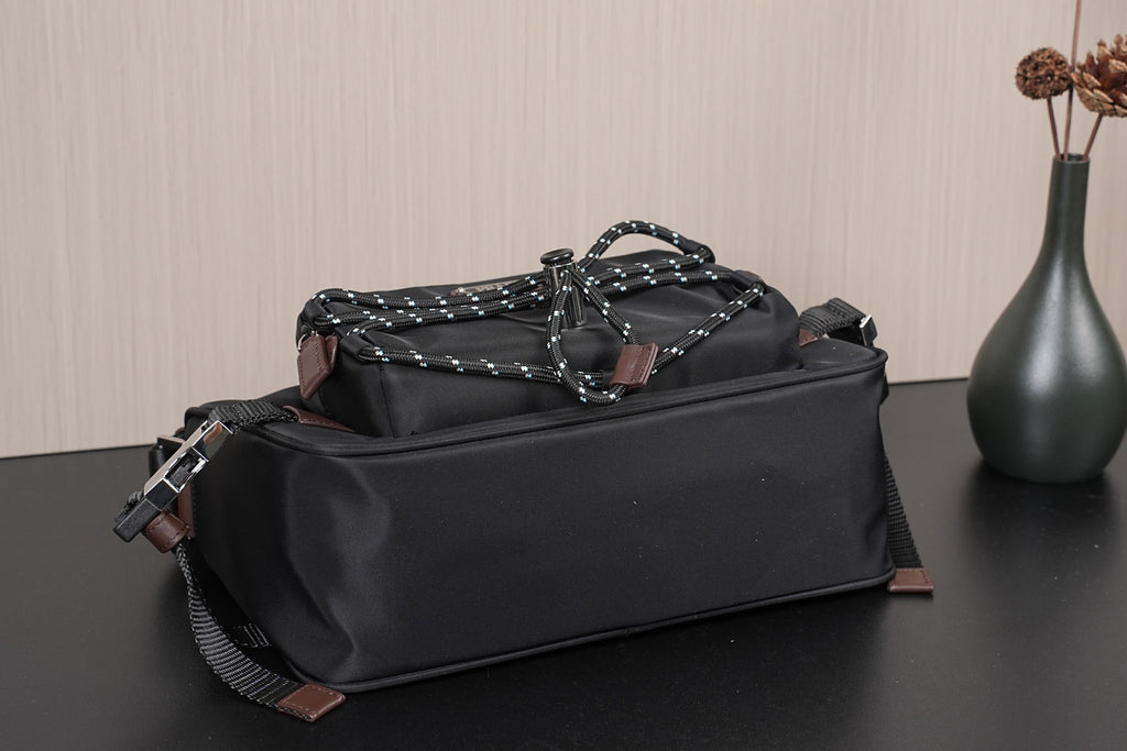 Black Prada bag with braided chain top handle and metal buckles