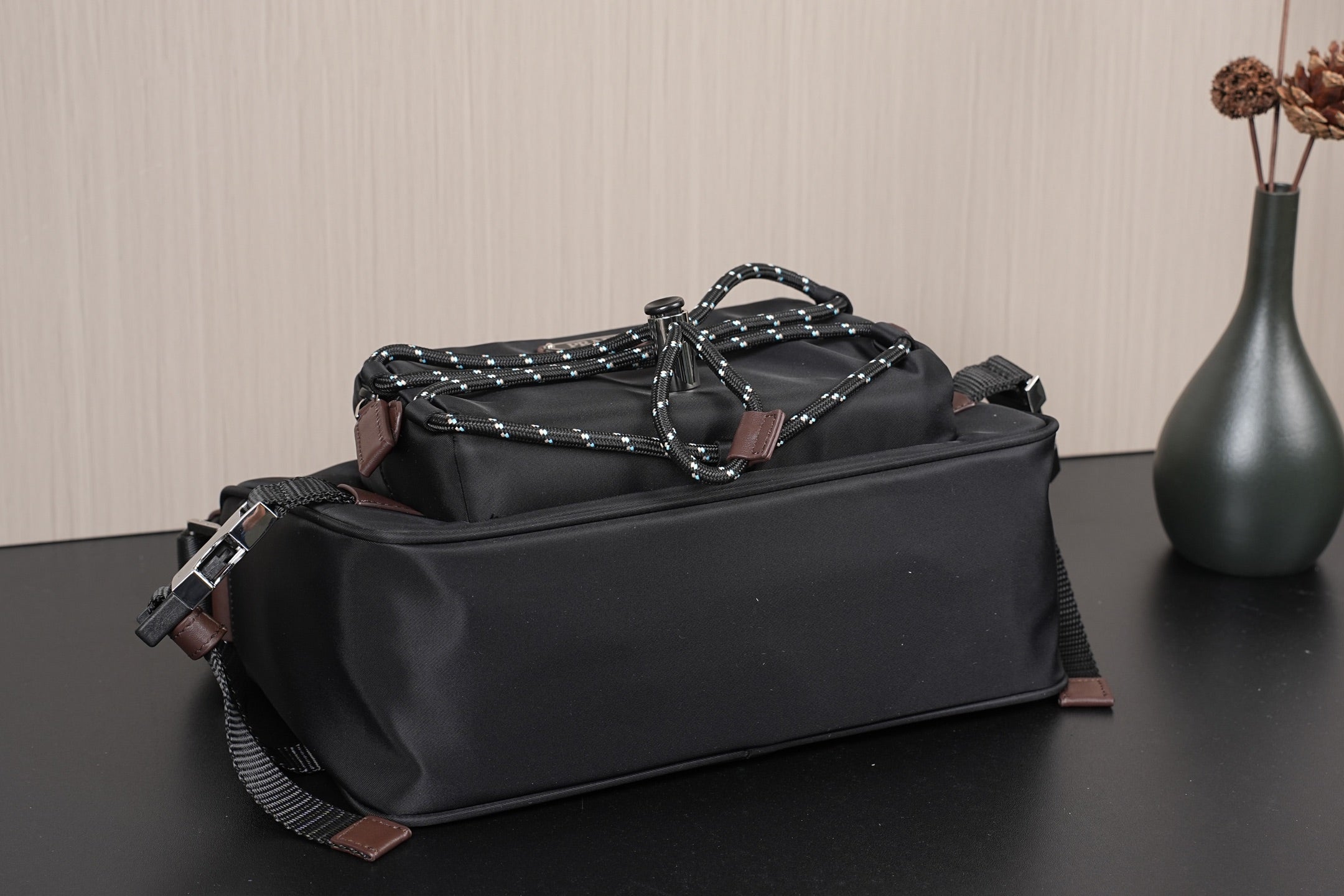 Black Prada bag with braided chain top handle and metal buckles