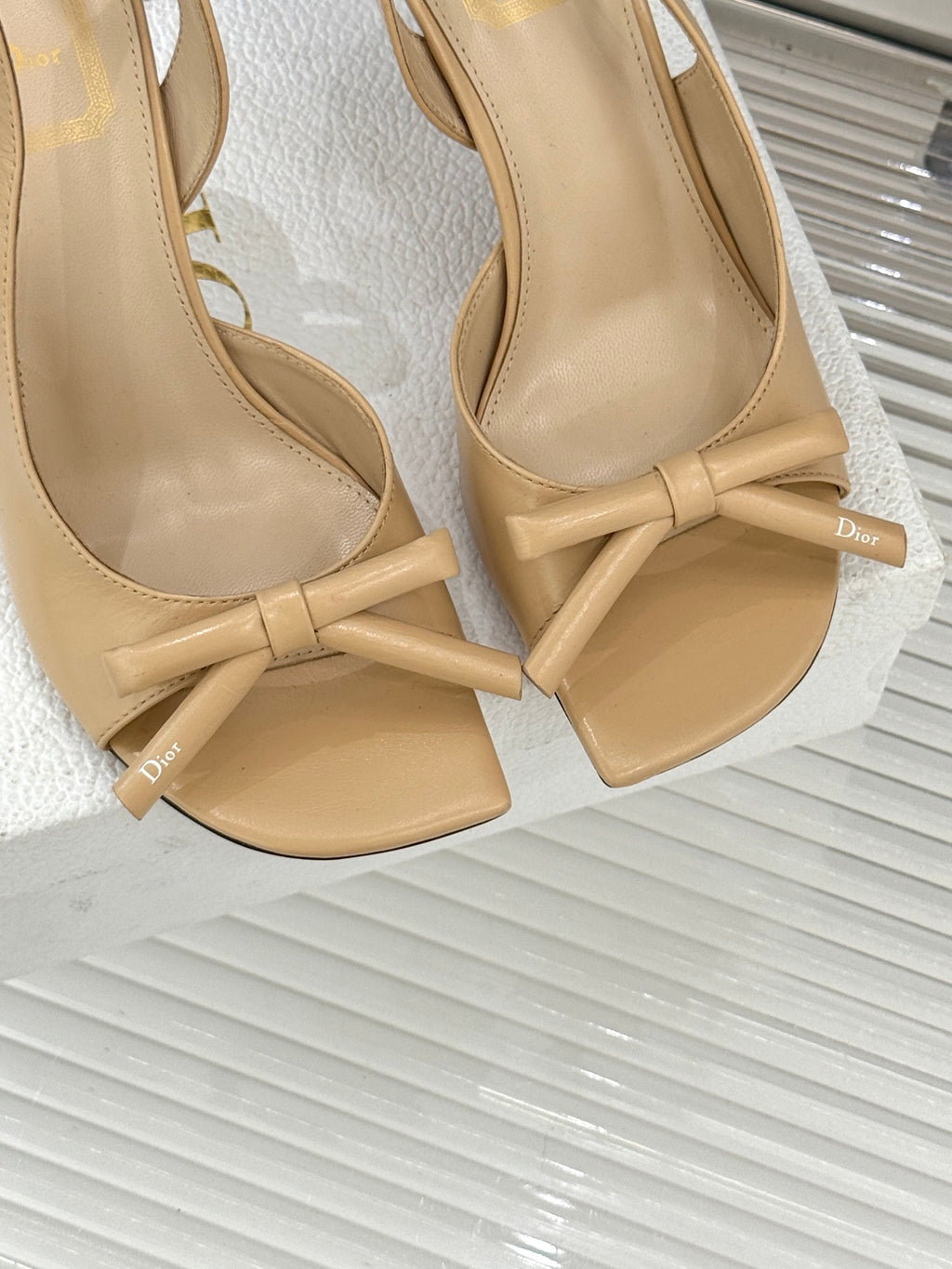 Beige open-toe heeled sandals with bow-knot straps and Dior logo insole