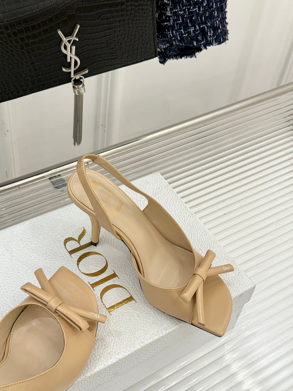 Beige open-toe heeled sandals with ankle tie bows and crossover straps