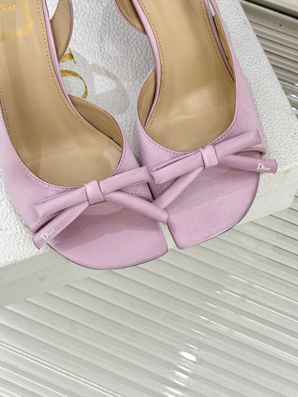 Lilac slingback pumps close-up of bow and Dior logo on insole