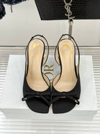 Black heeled bow sandals with open toe and beige insole