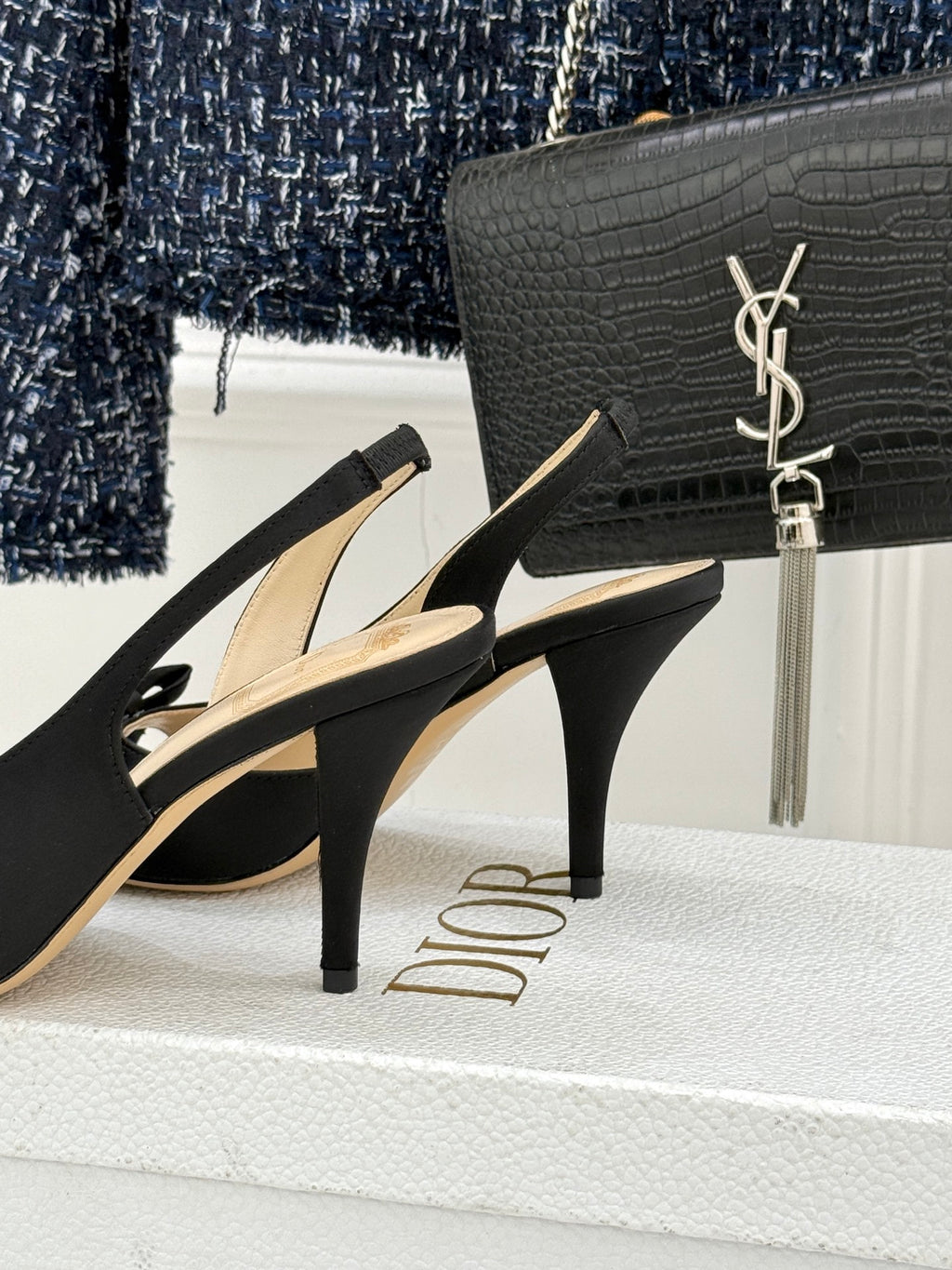 Black heeled sandals with bow straps and slim stiletto heel