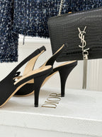 Black heeled sandals with bow straps and slim stiletto heel