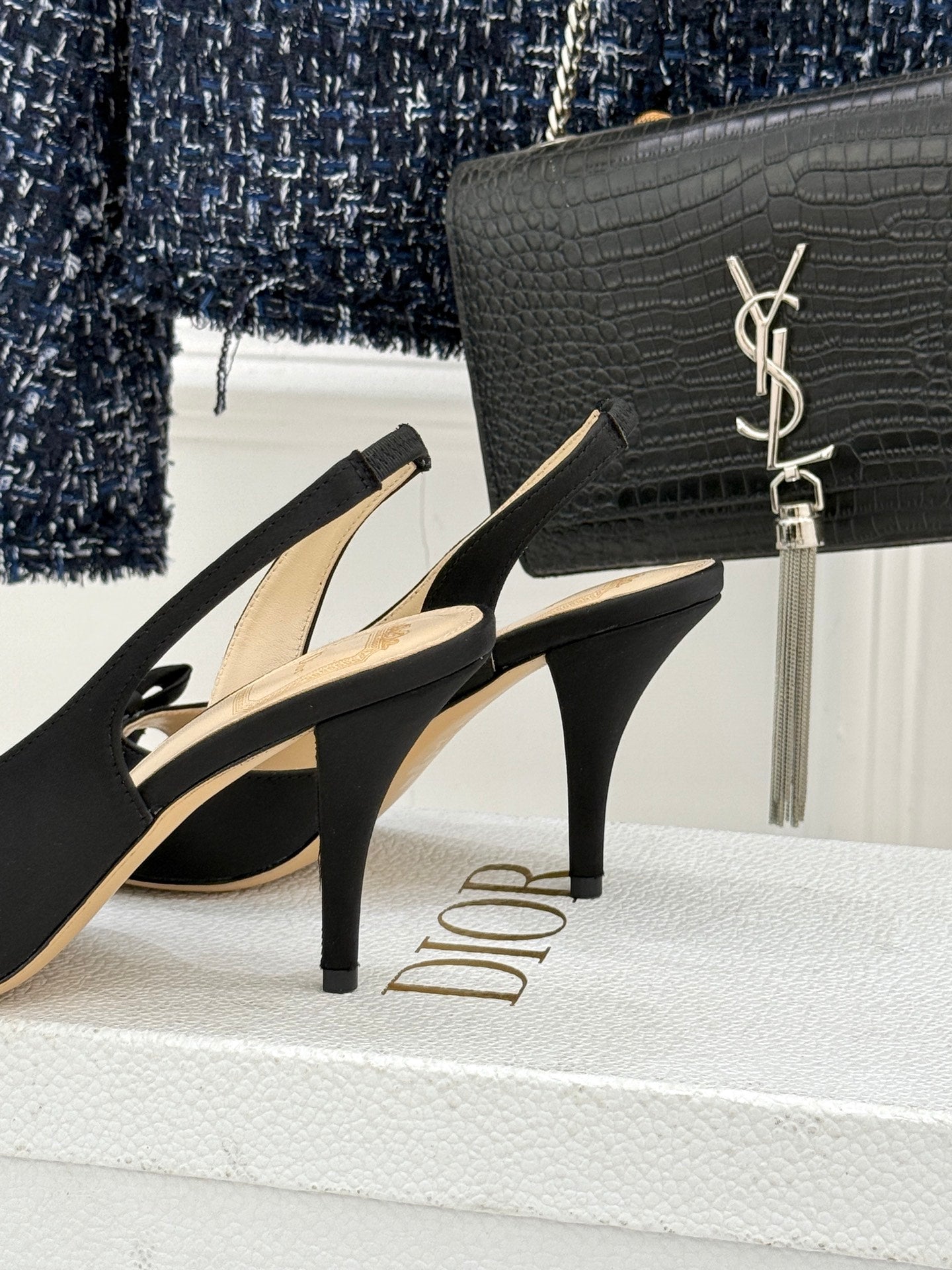 Black heeled sandals with bow straps and slim stiletto heel
