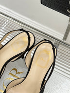 Black open-toe heeled sandal with thin ankle strap and beige lining