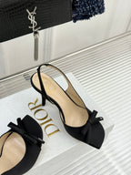 Black heeled sandal with large bow and thin ankle strap
