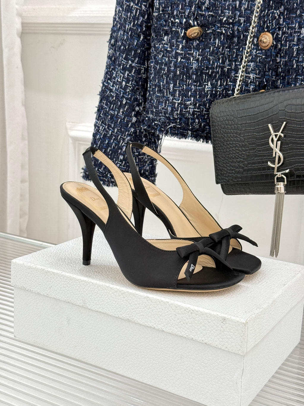 Black heeled sandal with crisscross straps and bow detail