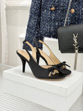 Black heeled sandal with crisscross straps and bow detail