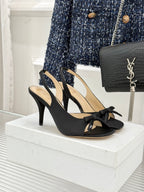 Black heeled sandal with crisscross straps and bow detail