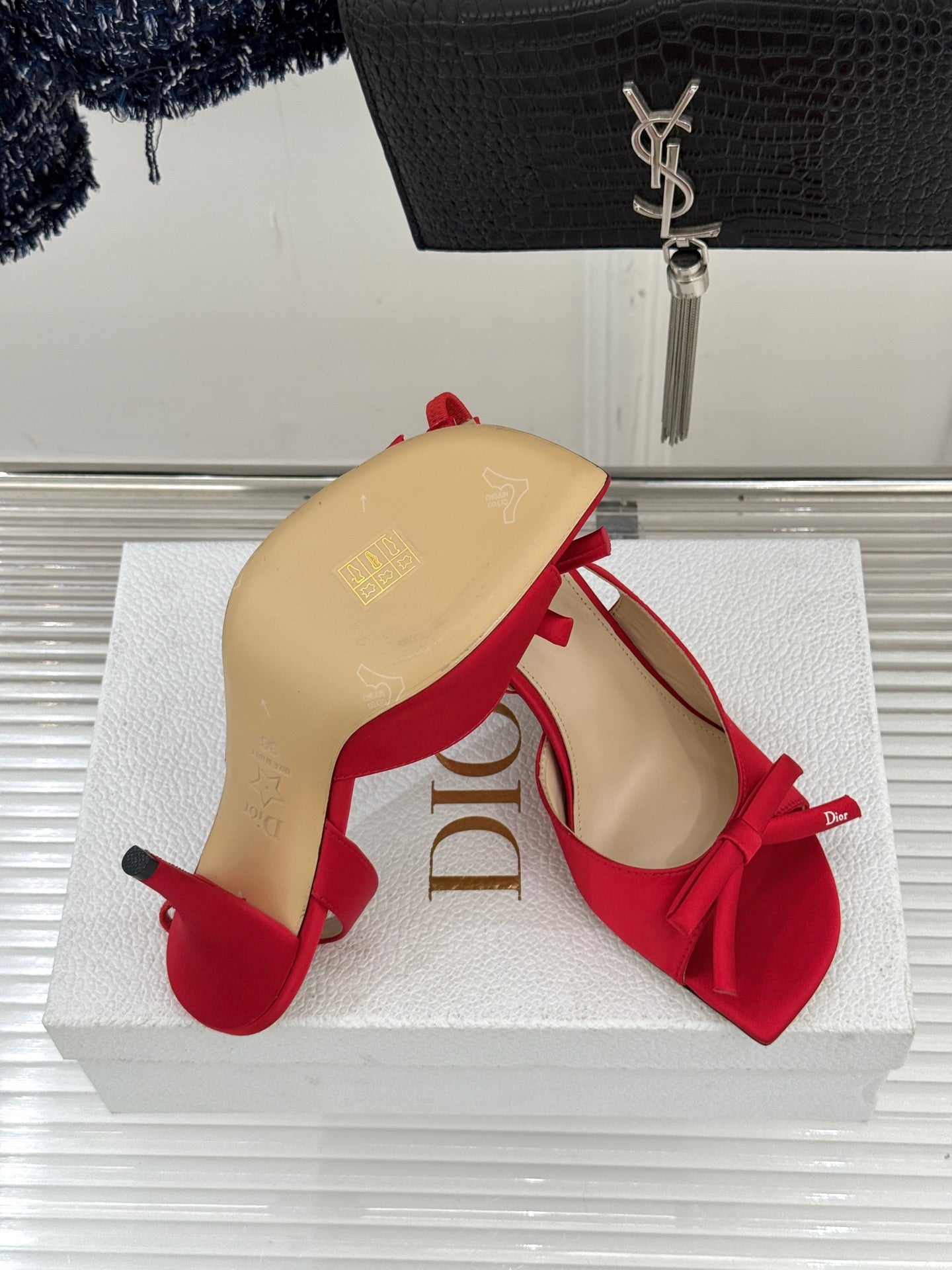Red stiletto slingback pumps with bow ties, heel and insole view