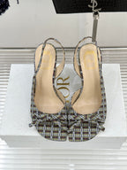 Pair of women’s plaid slingback heeled sandals with open toe and stiletto heels