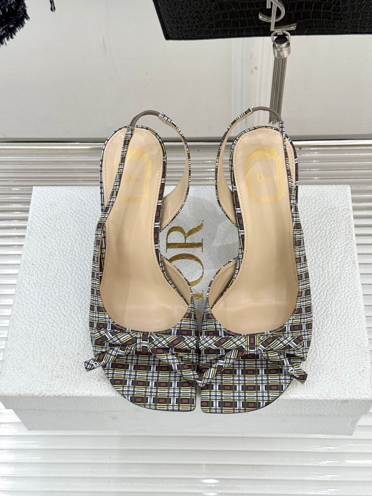 Pair of women’s plaid slingback heeled sandals with open toe and stiletto heels