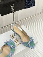 Dior plaid heeled sandals on display, blue-green checks with bow at front