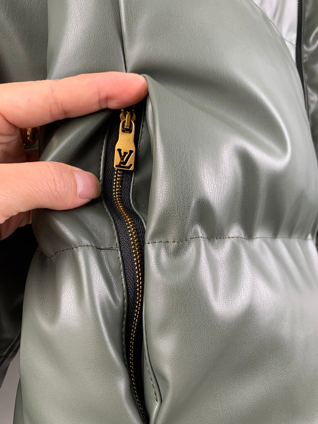 Louis Vuitton puffer jacket front, gold zipper pull detail