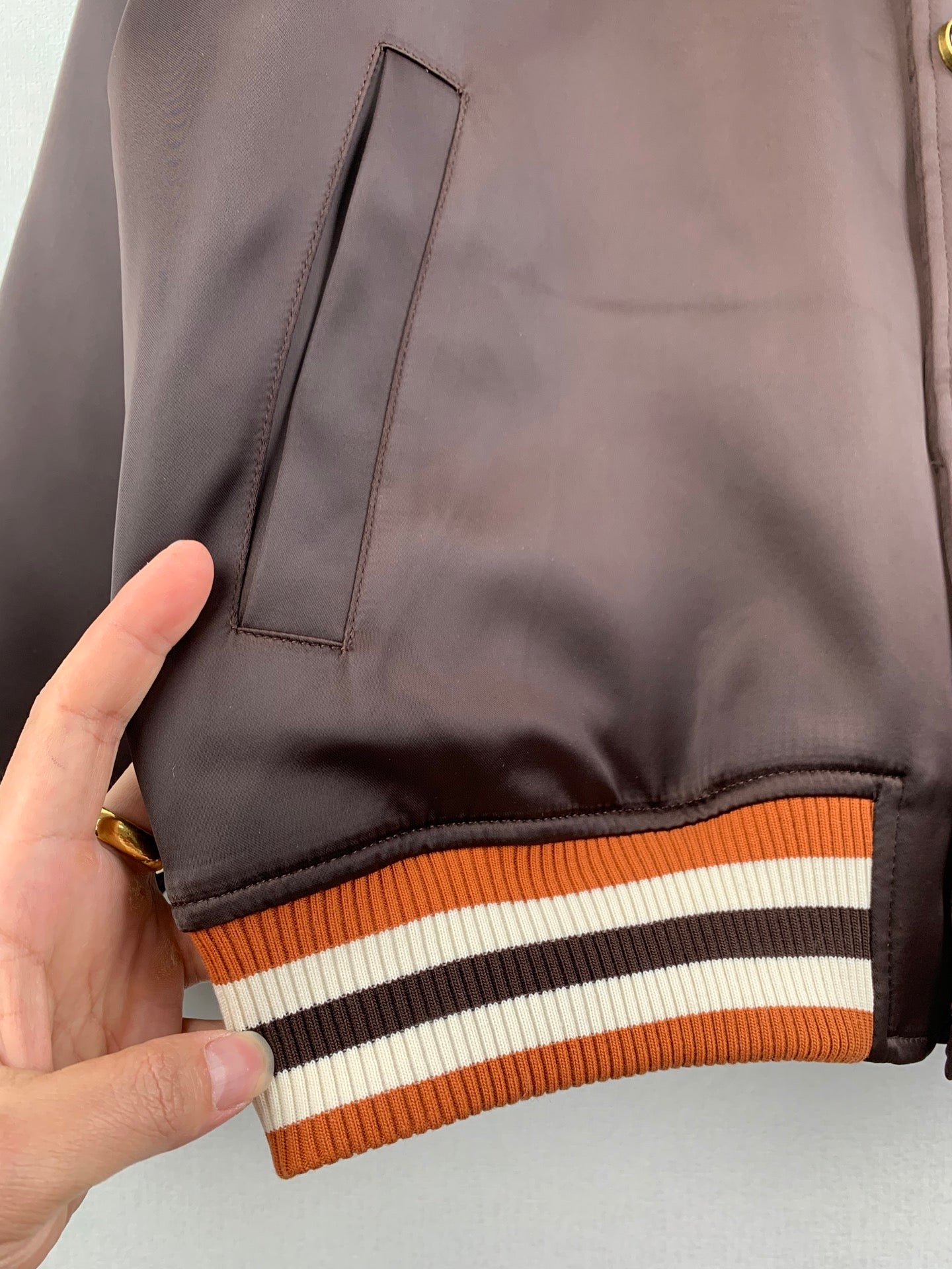 Louis Vuitton bomber jacket pocket, dark satin with striped ribbed hem trim