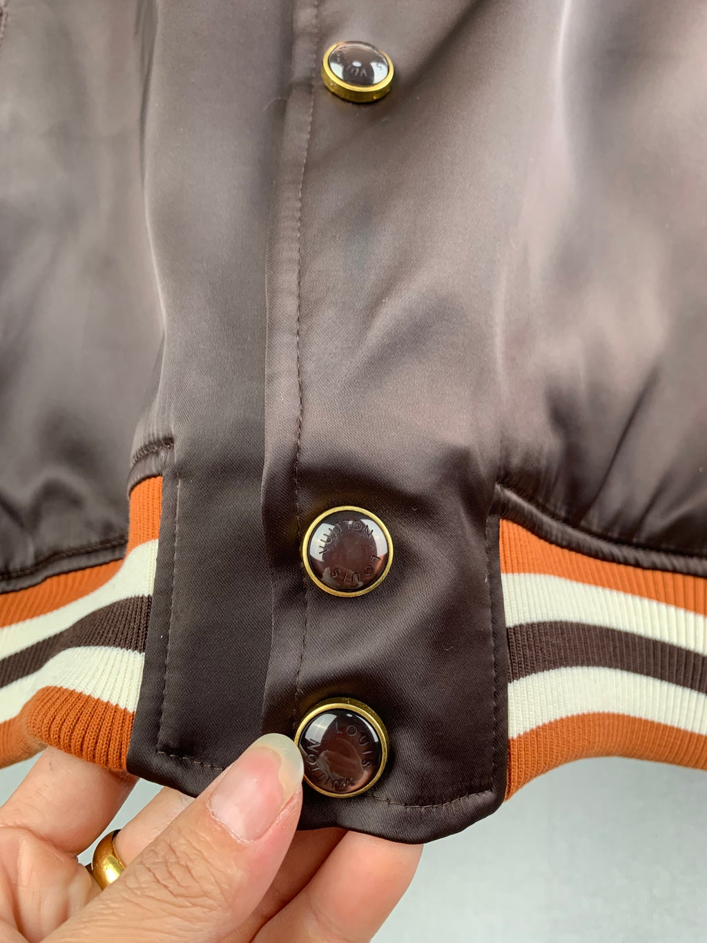Louis Vuitton bomber jacket sleeve cuff, striped ribbed hem and gold-tone snap buttons