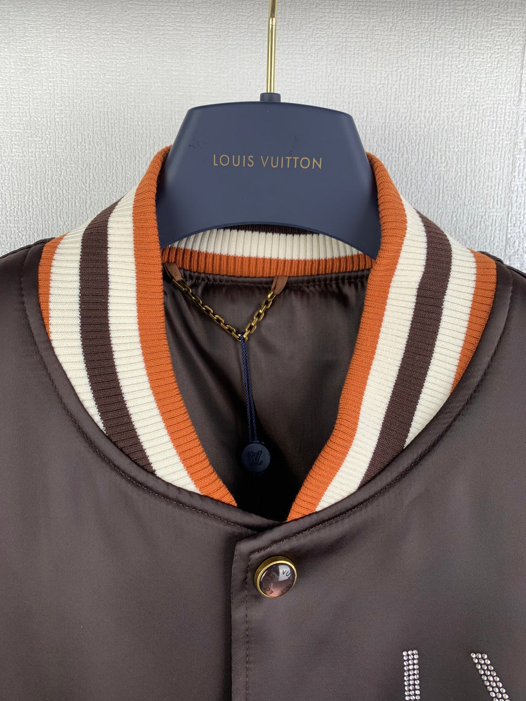 Louis Vuitton bomber jacket, dark satin, striped ribbed collar and button placket close-up