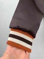 Louis Vuitton bomber jacket sleeve, dark satin with orange and striped ribbed hem