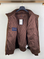 Brown Louis Vuitton monogram puffer vest on hanger with blue logo tag