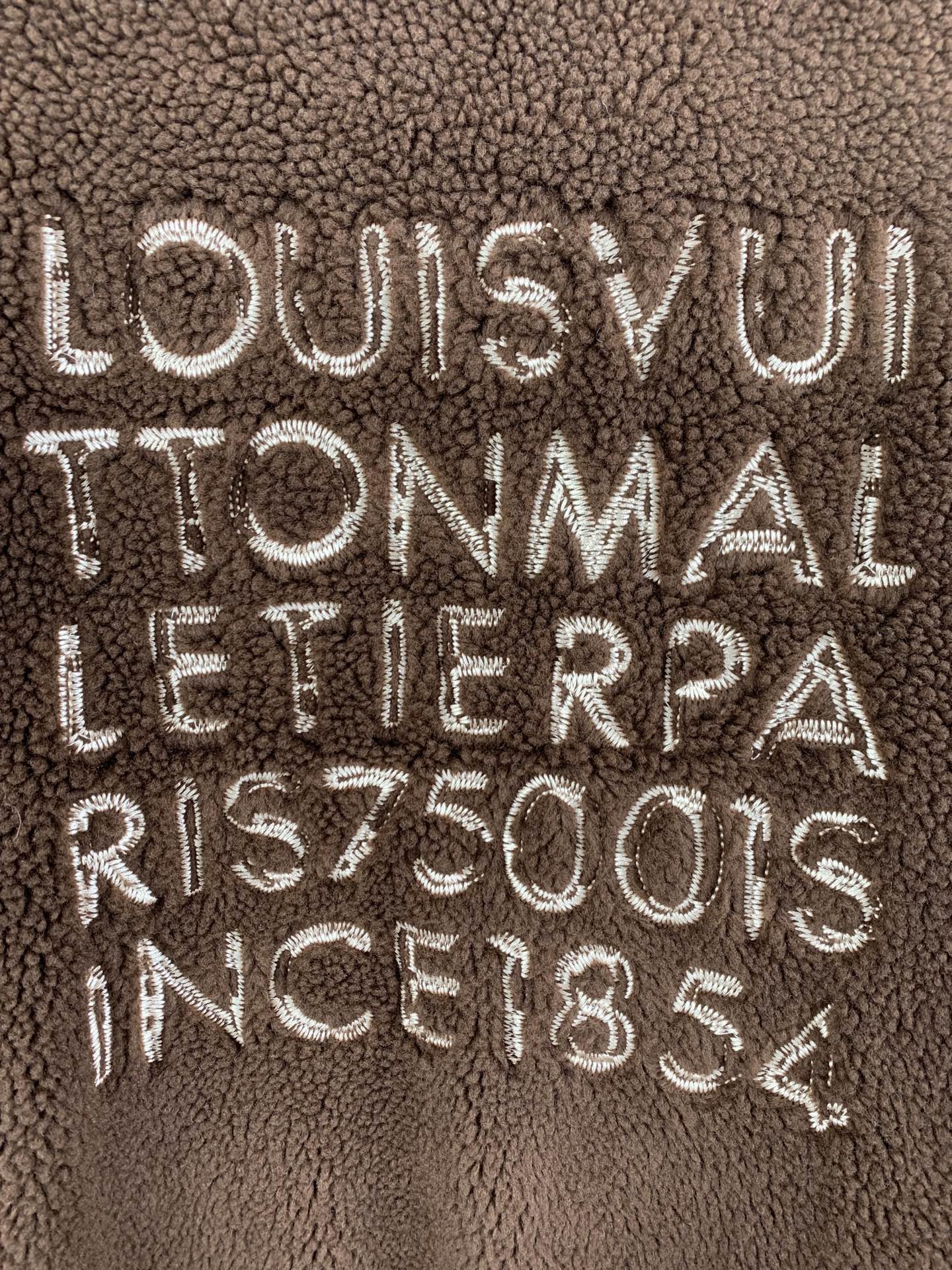Brown plush vest with embroidered LOUIS VUITTON TONMAL lettering