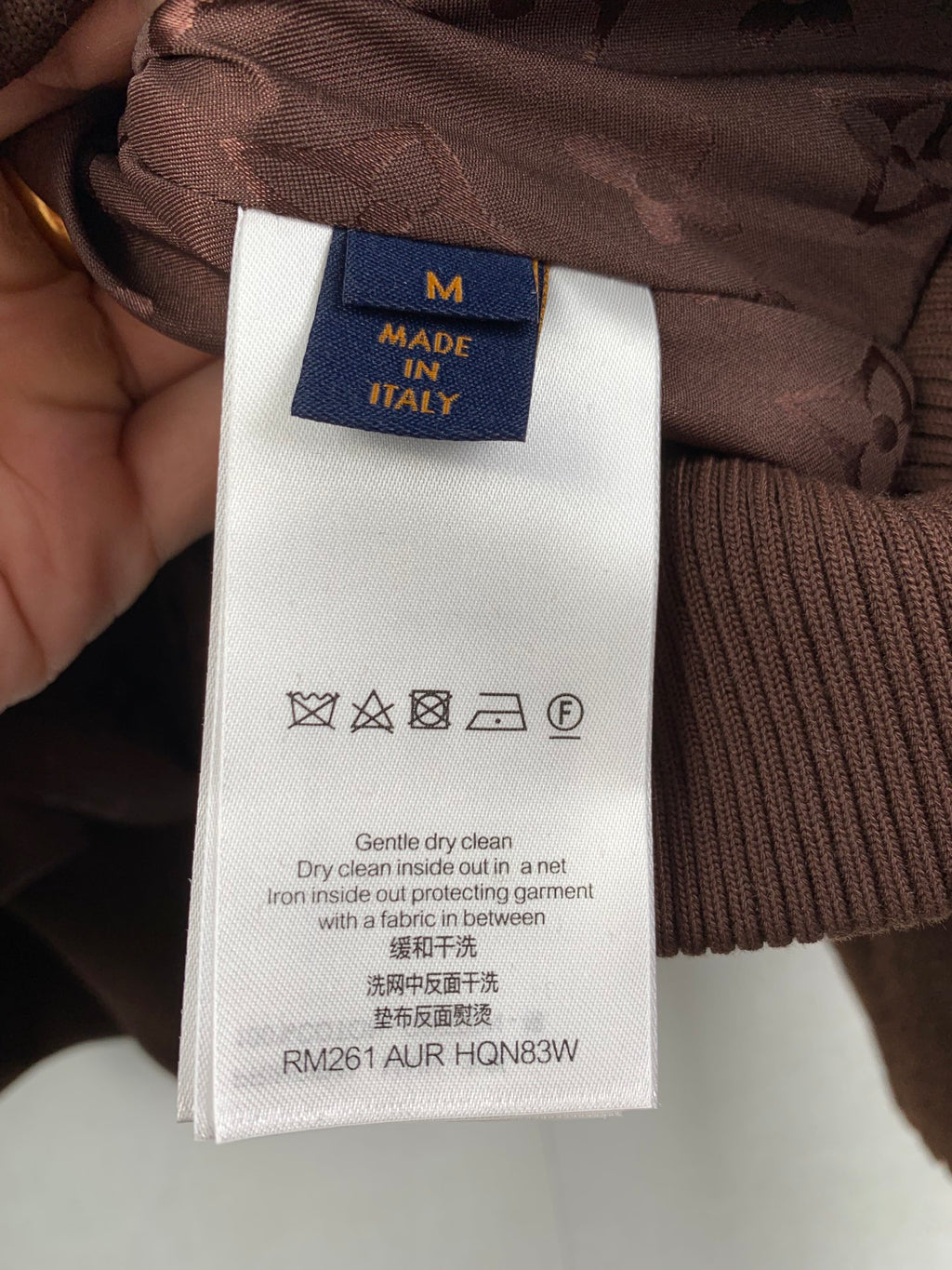 Brown long vest care label showing size M and Made in Italy