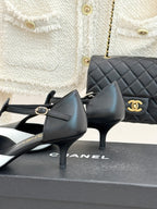 Chanel two-tone pointed pumps with black heels and white toe fronts