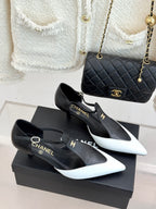 Chanel black-and-white pointed pumps with slingback straps and curved heels