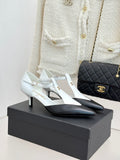 Chanel ladies slingback heels, white with black pointed toe and gold logo detail