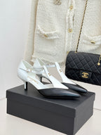 Chanel ladies slingback heels, white with black pointed toe and gold logo detail