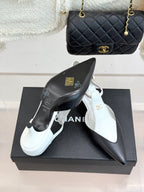Chanel ladies pointed-toe heels, black leather with gold logo and glossy finish