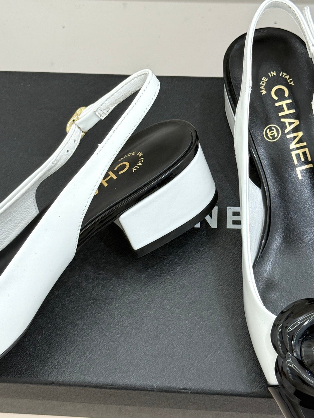 White slingback pumps with black interior and block heel