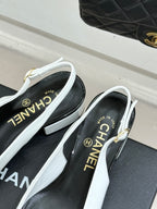 White slingback pumps with CHANEL logo insole and block heel