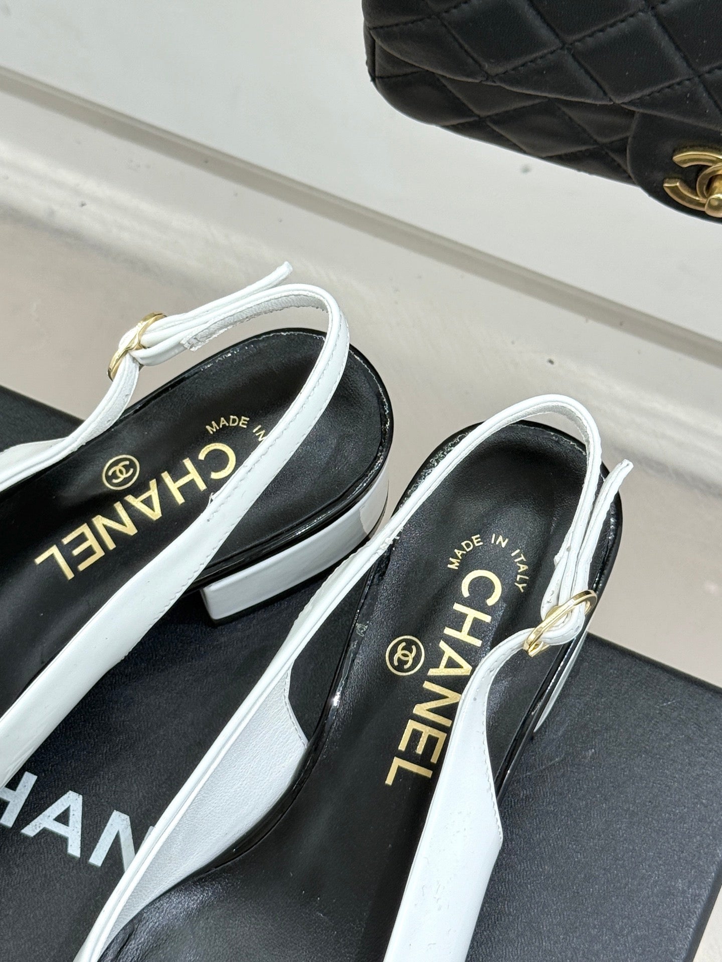 White slingback pumps with CHANEL logo insole and block heel