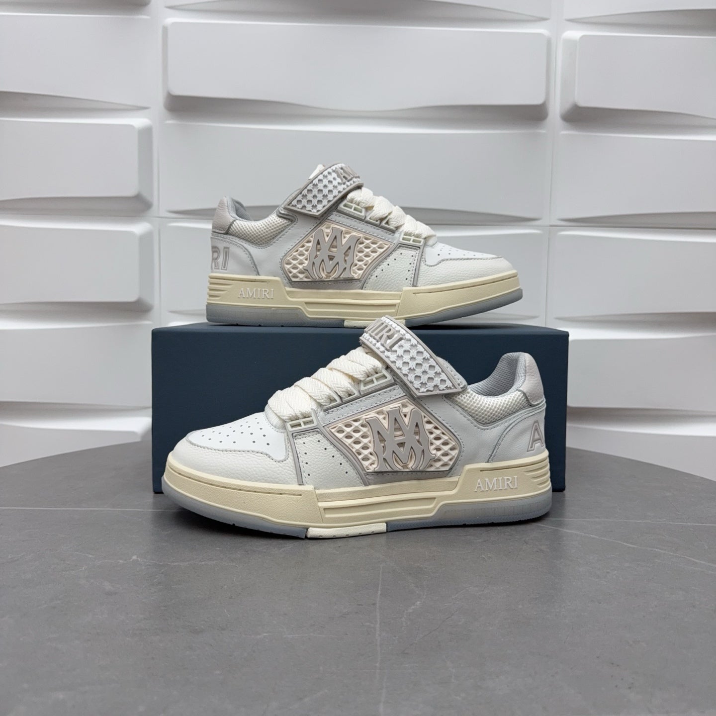 Amiri low-top sneakers in white with studded strap and logo patch on side