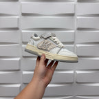 Amiri low-top sneaker held in white with patterned studded strap and chunky sole