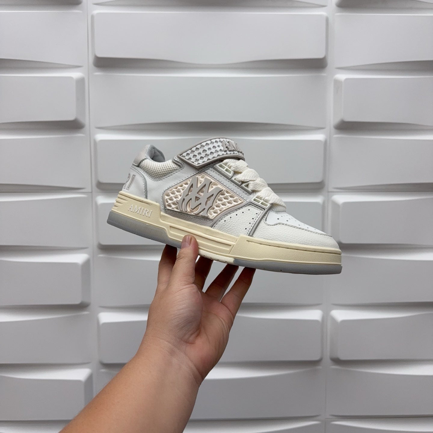 Amiri low-top sneaker held in white with patterned studded strap and chunky sole