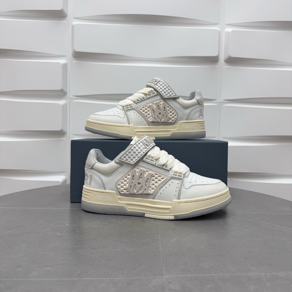 Amiri low-top sneakers in white with studded strap, lace-up, and chunky sole