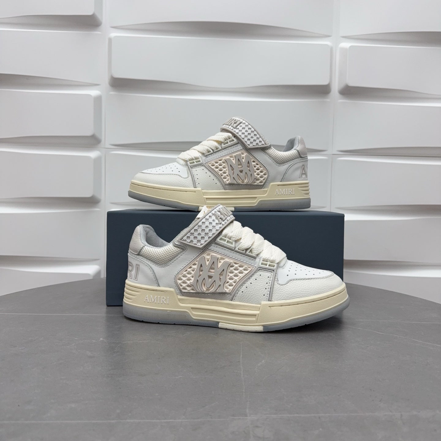 Amiri low-top sneakers in white with studded strap, lace-up, and chunky sole